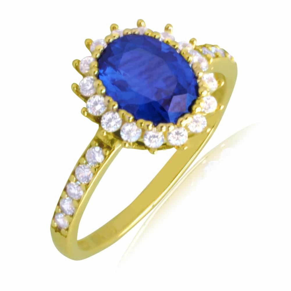 Ροζέτα δαχτυλίδι από χρυσό 14Κ, σε οβάλ σχήμα. Είναι διακοσμημένο με ένα οβάλ μπλε ζιργκόν στο κέντρο και λευκά περιμετρικά.