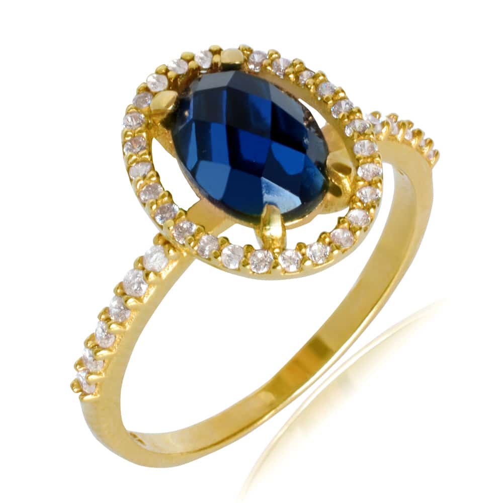 Δαχτυλίδι ροζέτα οβάλ από χρυσό 14Κ. Είναι διακοσμημένη με μπλε ζιργκόν στο κέντρο και λευκά περιμετρικά.